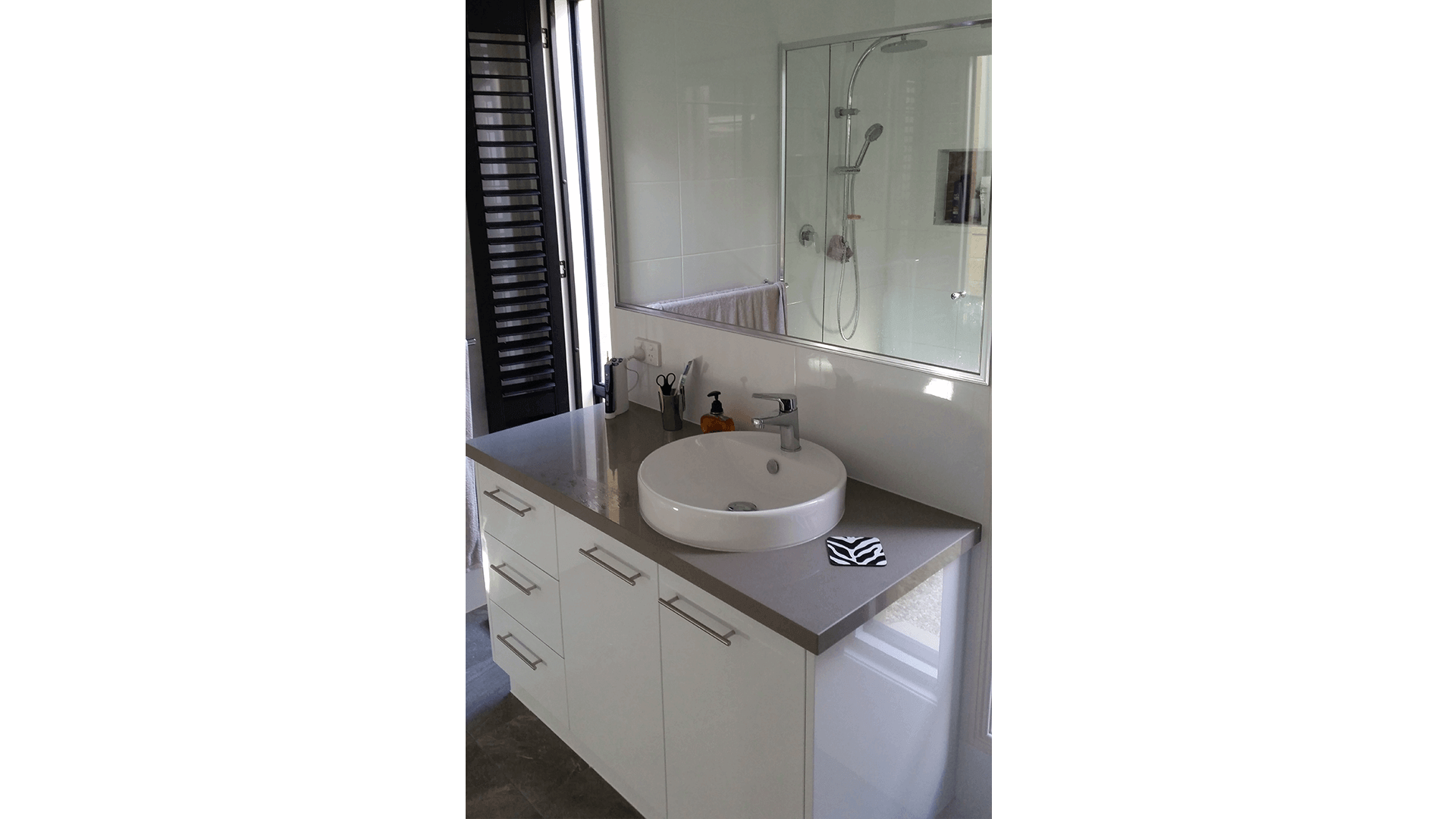 Round above bench vanity basin with pivot door shower and Twin Shower Rail