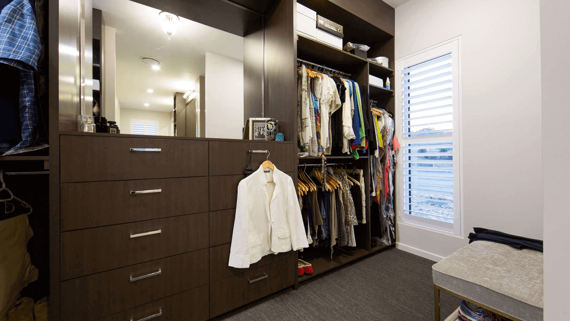 Customised walk in robe / dressing room, cupboards built in timber grain laminate with large mirror